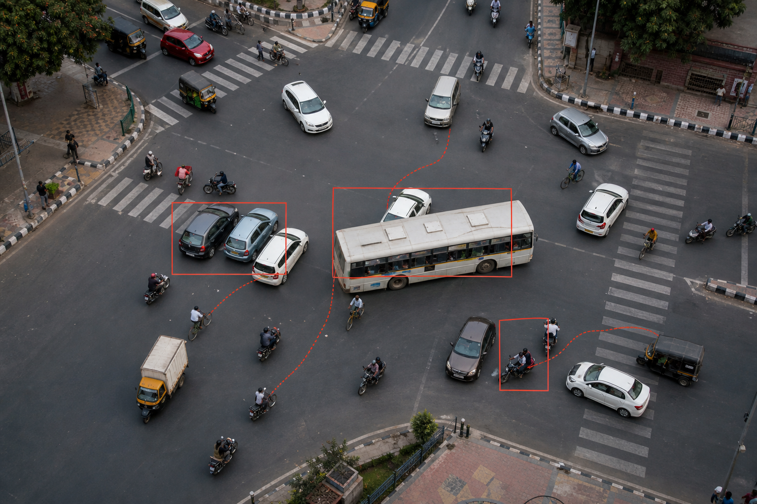 Synthetic overhead intersection illustrating overlap, bus occlusion and dense mixed traffic